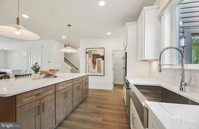 a kitchen with a sink stove and cabinets