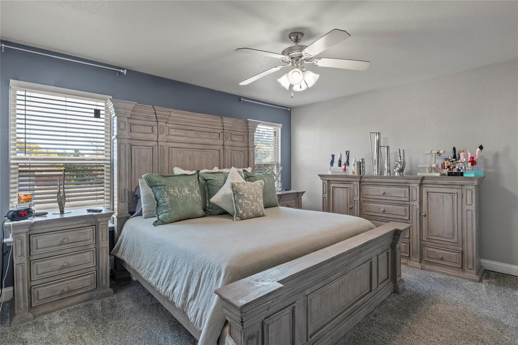 8342 Timberbrook Lane Dallas, TX 75249 - Photo 13 of 25 a bedroom with a bed and a chandelier