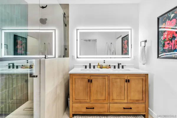 a bathroom with a shower sink and mirror
