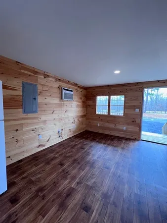 a view of a room with wooden floor and window