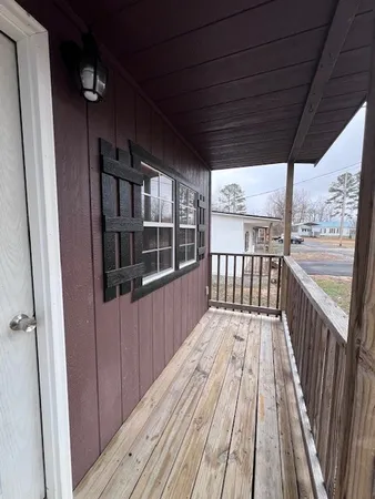 a view of a balcony with wooden floor
