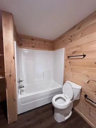 a bathroom with a toilet and a bath tub