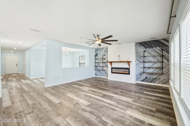 a large kitchen with stainless steel appliances kitchen island granite countertop a refrigerator and a sink