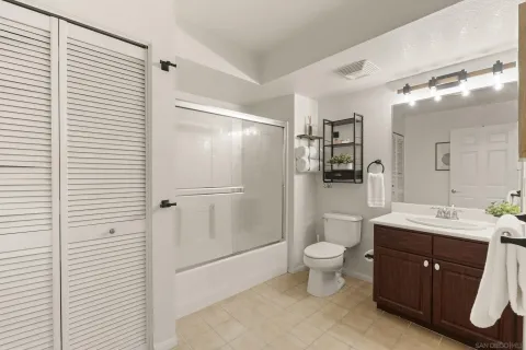 a bathroom with a double vanity sink toilet and shower