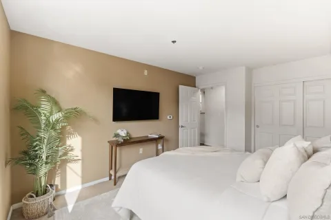 a bedroom with a bed and a flat screen tv