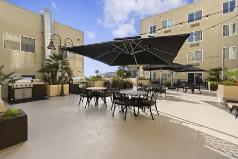 a view of a patio with table and chairs under an umbrella