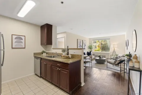 a living room with granite countertop furniture and a wooden floor
