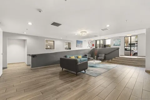 a living room with furniture and wooden floor