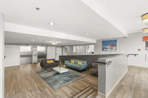 a living room with furniture and a wooden floor