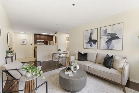 a living room with furniture and a view of kitchen