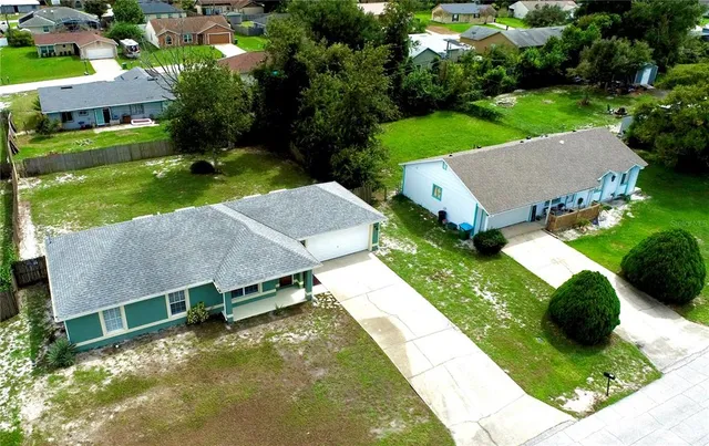 an aerial view of a house with swimming pool garden and patio