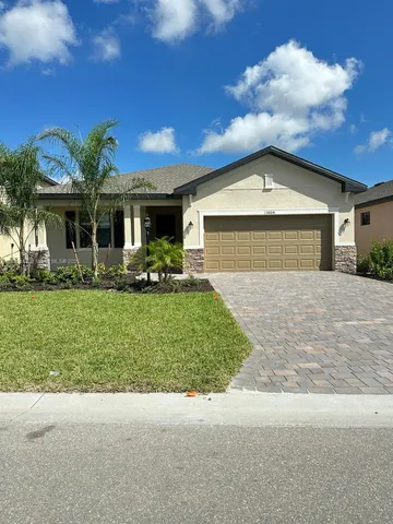 a front view of a house with a garden and yard