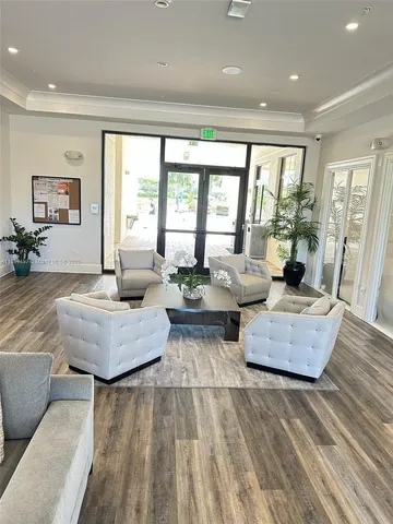 a living room with furniture and large windows