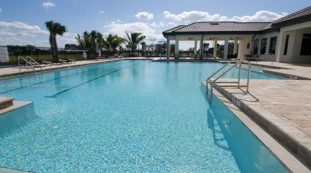 a view of a swimming pool with chairs