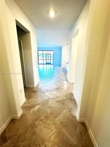 a view of entryway with a window and wooden floor