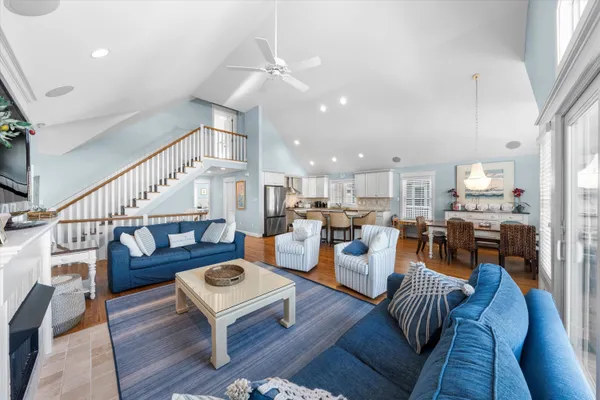 a kitchen with stainless steel appliances granite countertop a dining table chairs refrigerator sink and cabinets