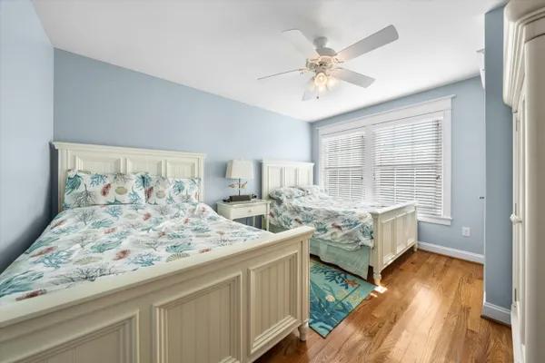 a spacious bedroom with a bed and a dresser