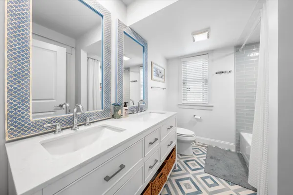 a bathroom with a tub a sink and mirror