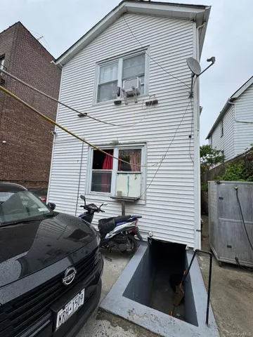a view of a white car parked in front of a house