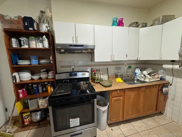 a kitchen with stainless steel appliances granite countertop a stove and a cabinets