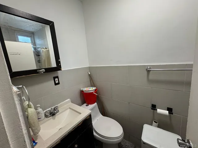 a white toilet sitting next to a bathroom sink