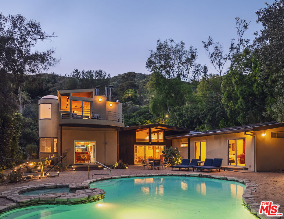 an aerial view of a house with swimming pool outdoor seating and yard