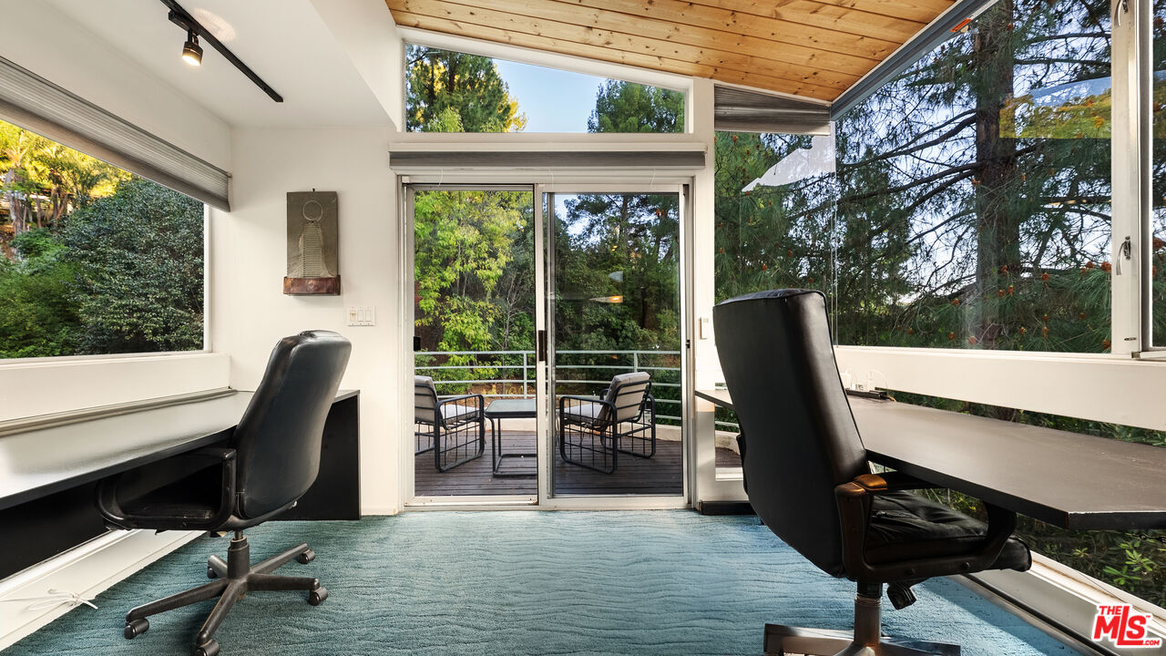13044 Sky Valley Road Los Angeles, CA 90049 - Photo 12 of 29 a view of a chair and table in the balcony