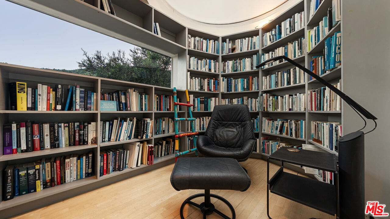 13044 Sky Valley Road Los Angeles, CA 90049 - Photo 16 of 29 a view of a book shelf with a livingroom