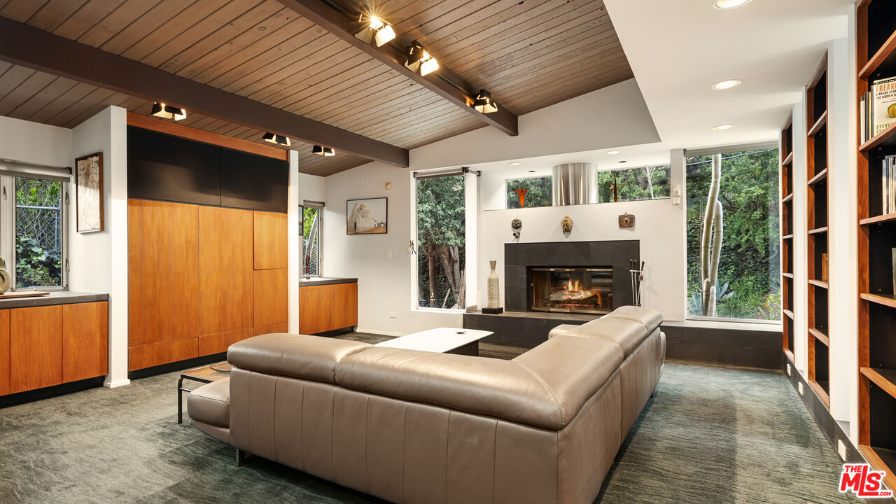 13044 Sky Valley Road Los Angeles, CA 90049 - Photo 18 of 29 a living room with furniture and a fireplace