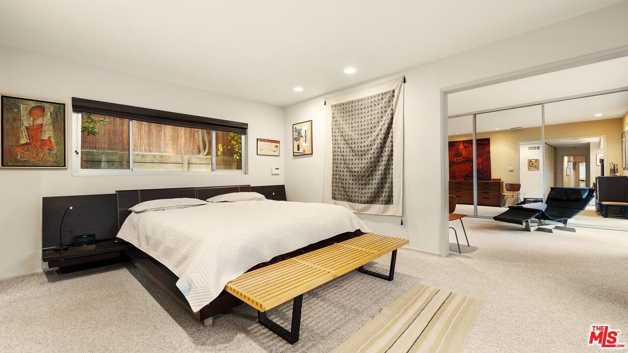 13044 Sky Valley Road Los Angeles, CA 90049 - Photo 20 of 29 a bedroom with a bed a mirror and a desk