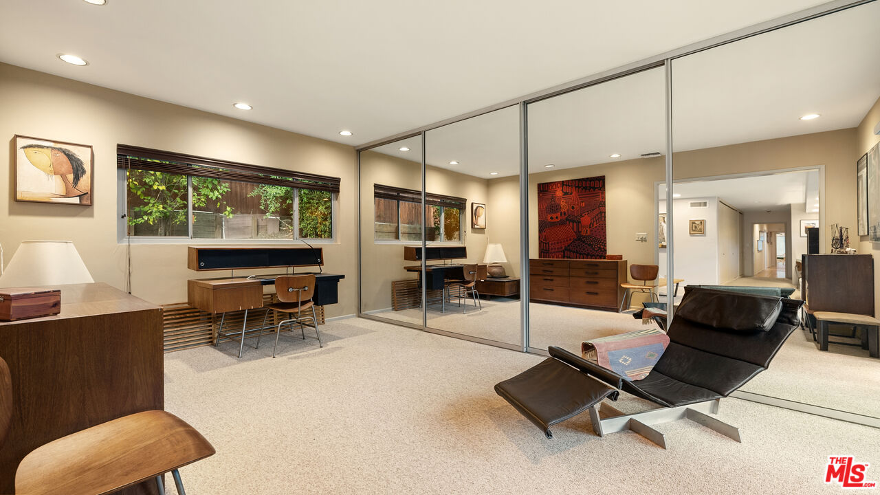 13044 Sky Valley Road Los Angeles, CA 90049 - Photo 21 of 29 a living room with furniture a large window and stainless steel appliances