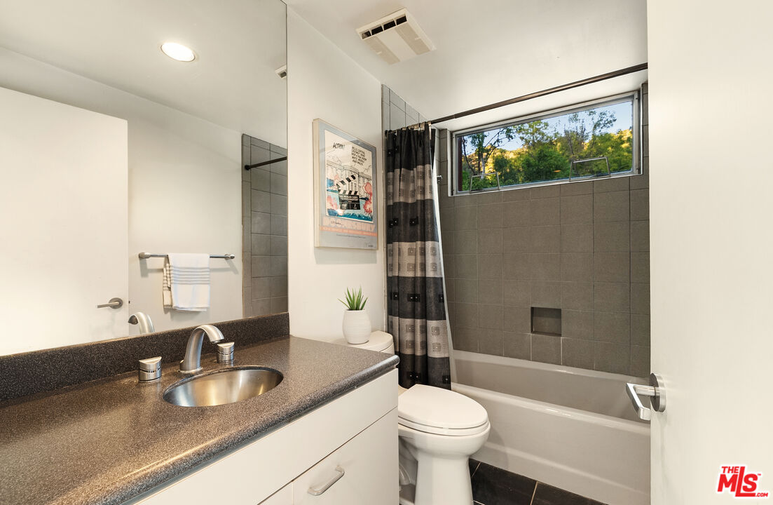 13044 Sky Valley Road Los Angeles, CA 90049 - Photo 24 of 29 a bathroom with a sink a toilet and shower