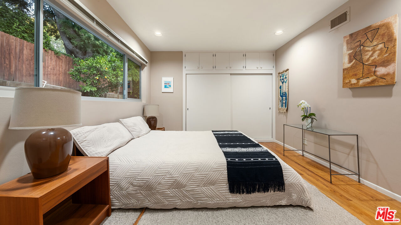 13044 Sky Valley Road Los Angeles, CA 90049 - Photo 25 of 29 a bedroom with a bed and a large window