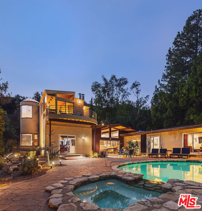 13044 Sky Valley Road Los Angeles, CA 90049 - Photo 26 of 29 front view of a building with a yard