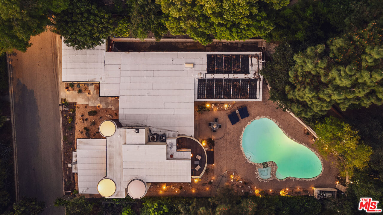 13044 Sky Valley Road Los Angeles, CA 90049 - Photo 28 of 29 aerial view of a house with swimming pool and trees