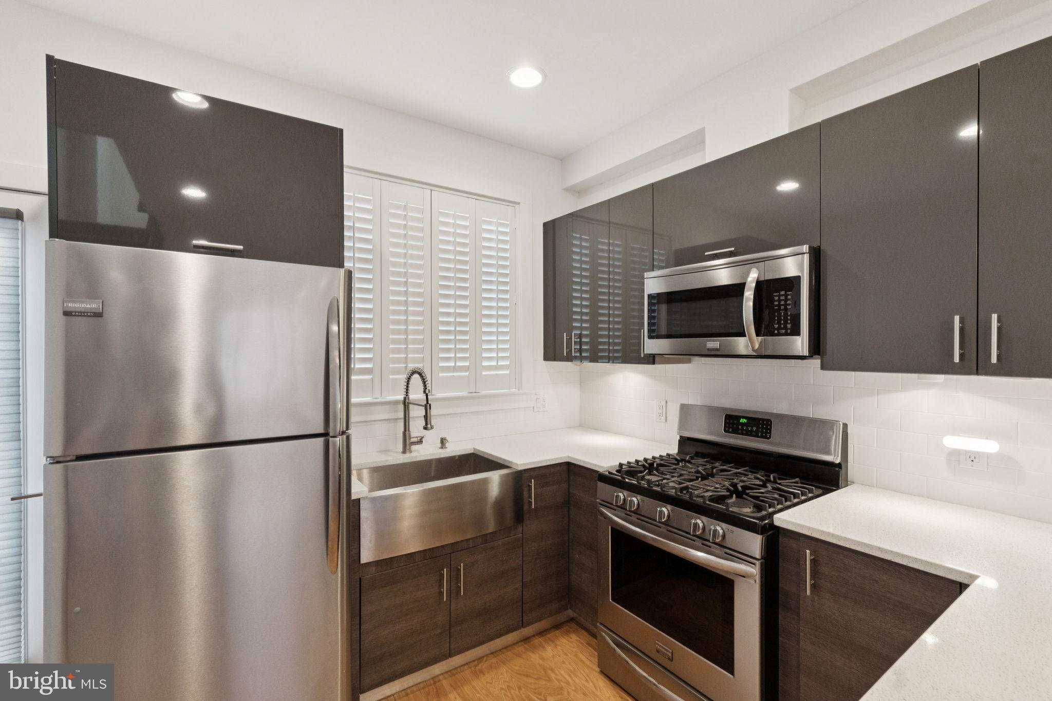 1825 Gerritt Street Philadelphia, PA 19146 - Photo 11 of 34 a kitchen with stainless steel appliances granite countertop a refrigerator and a stove top oven
