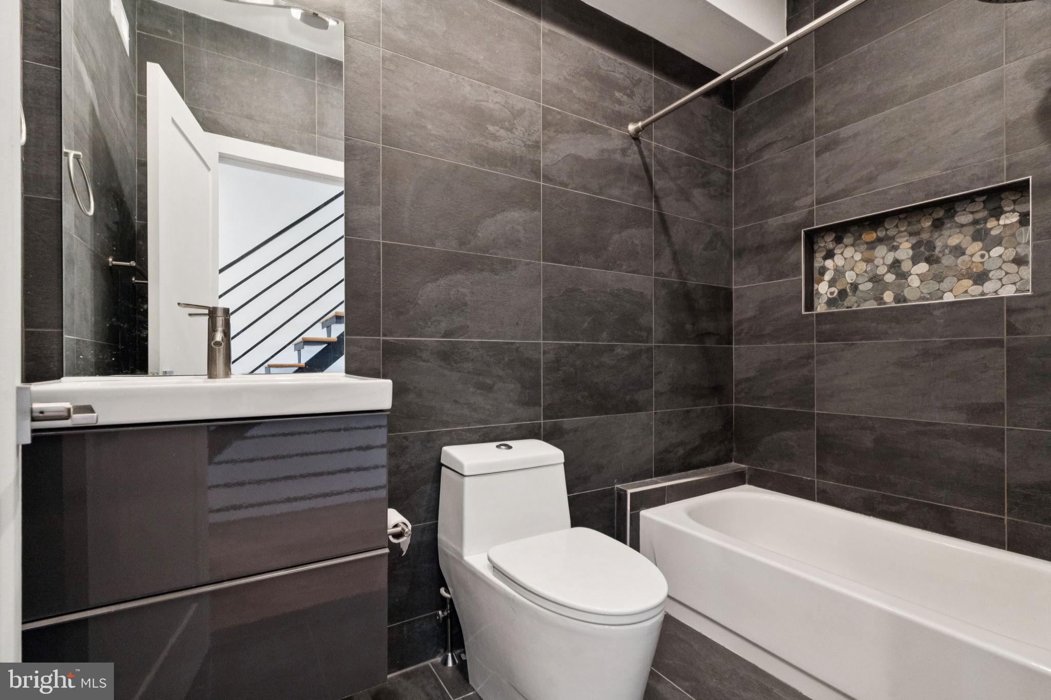 1825 Gerritt Street Philadelphia, PA 19146 - Photo 27 of 34 a bathroom with a toilet a sink and bathtub