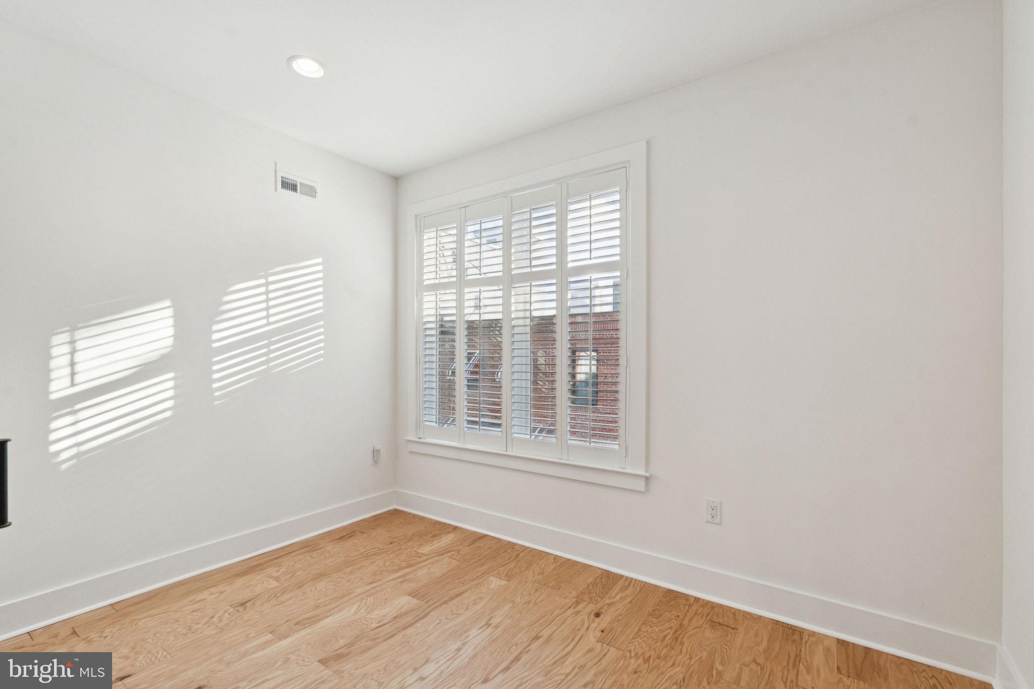 1825 Gerritt Street Philadelphia, PA 19146 - Photo 28 of 34 a view of an empty room with wooden floor and a window
