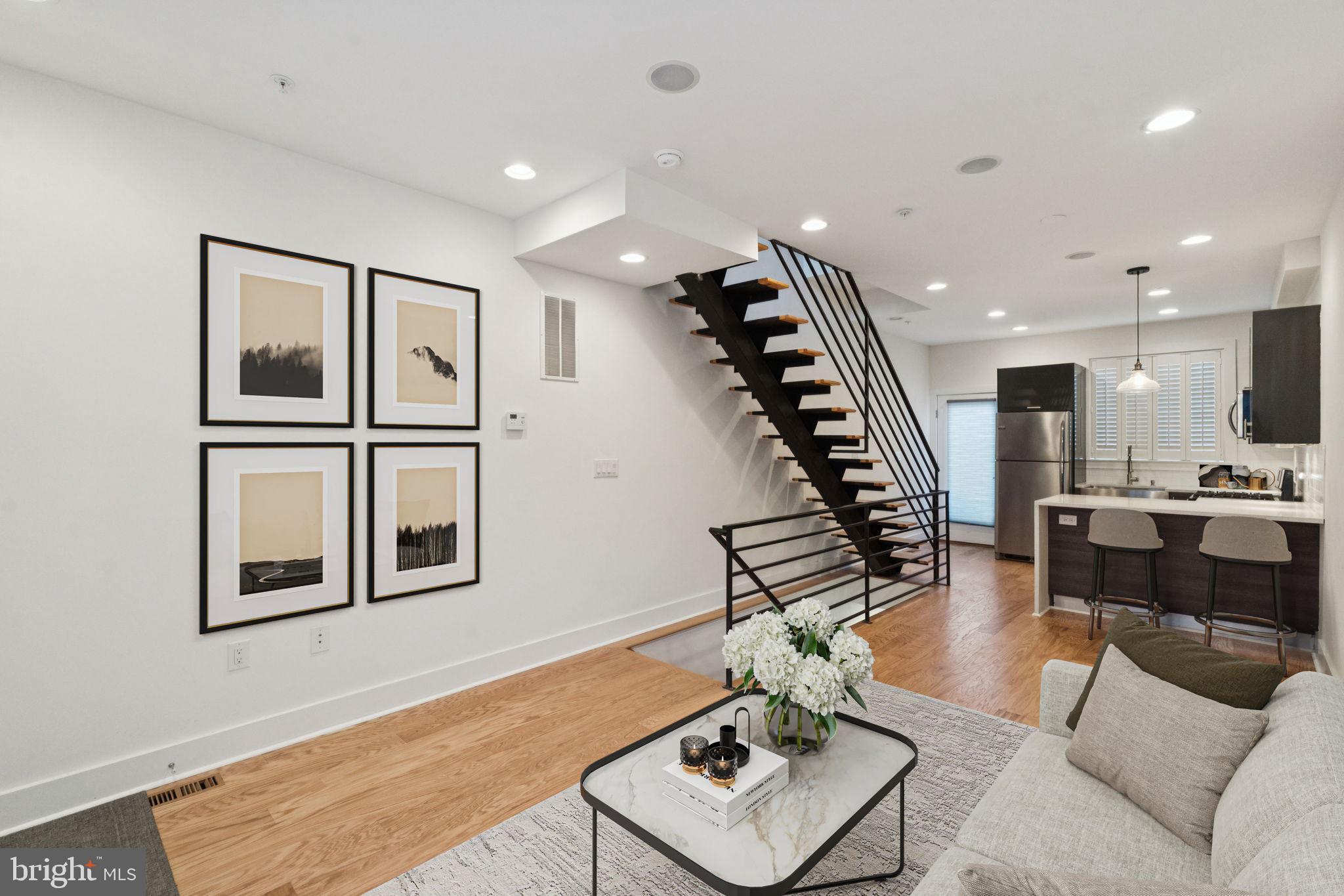 1825 Gerritt Street Philadelphia, PA 19146 - Photo 3 of 34 a living room with furniture kitchen view and a wooden floor