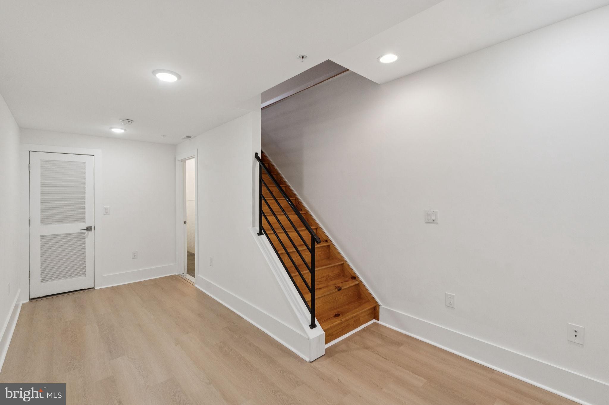 1825 Gerritt Street Philadelphia, PA 19146 - Photo 33 of 34 a view of an empty room with wooden floor and stairs