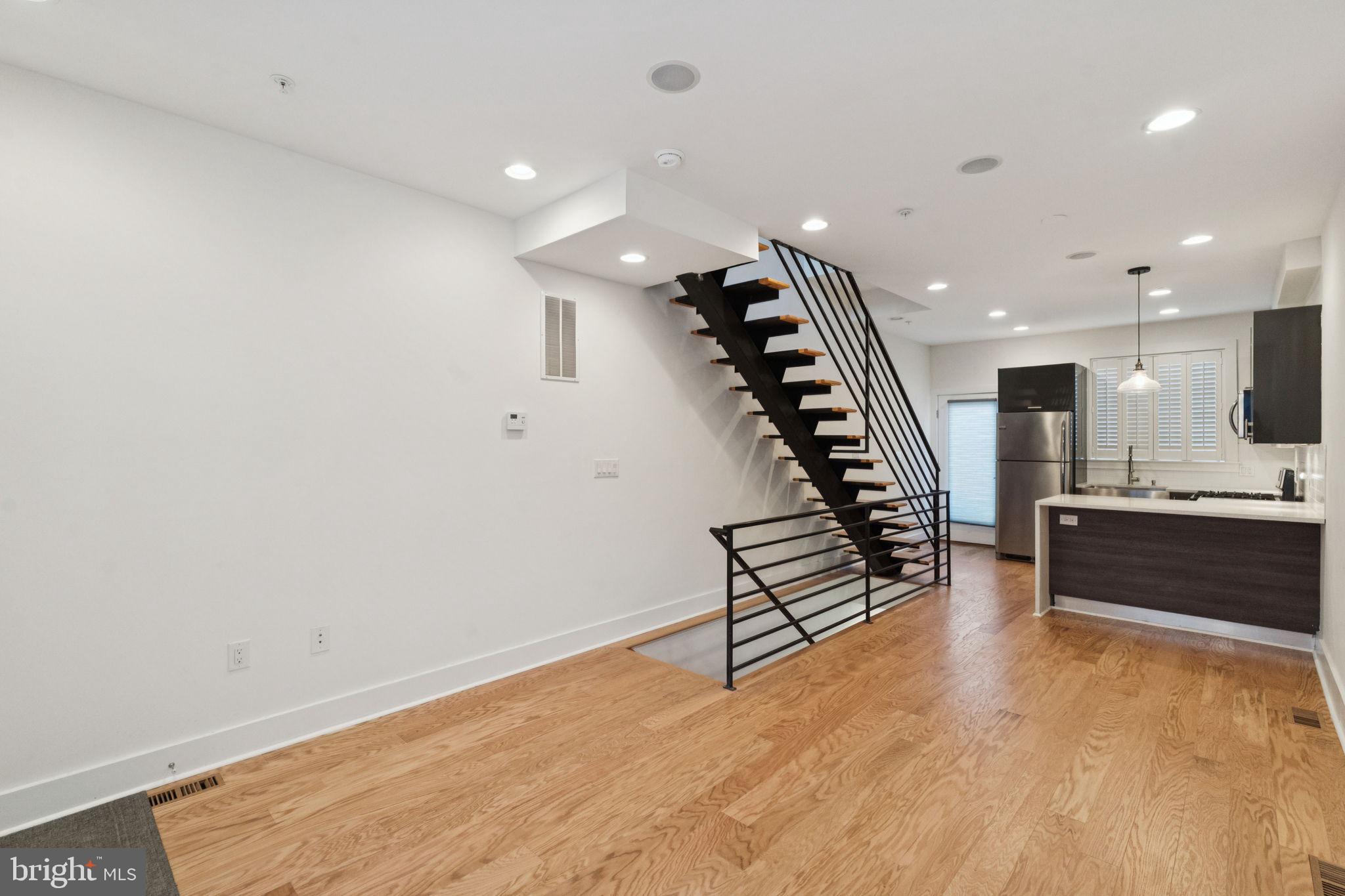1825 Gerritt Street Philadelphia, PA 19146 - Photo 4 of 34 an empty room with wooden floor and stairs