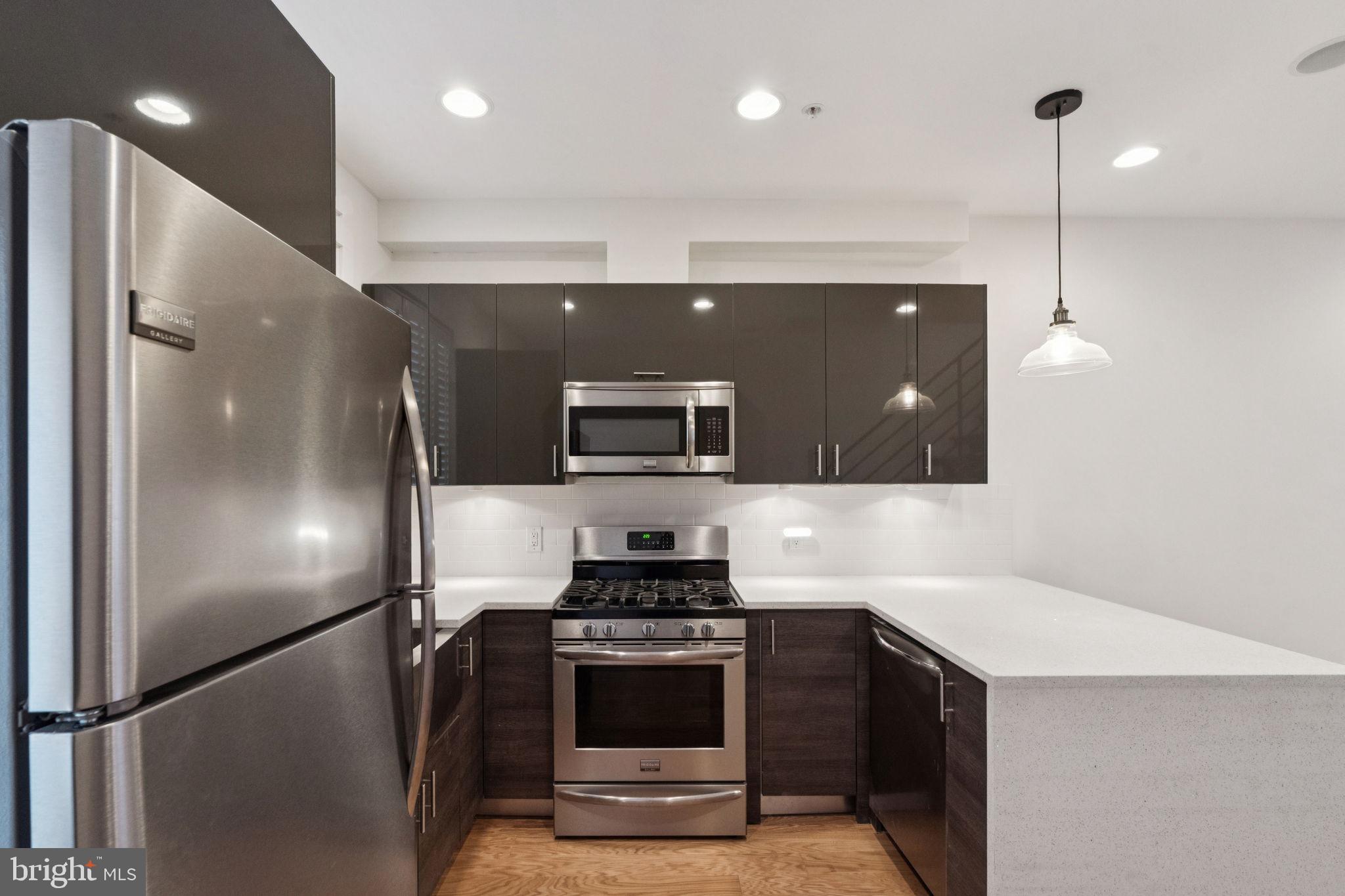1825 Gerritt Street Philadelphia, PA 19146 - Photo 10 of 34 a kitchen with kitchen island a refrigerator and a stove