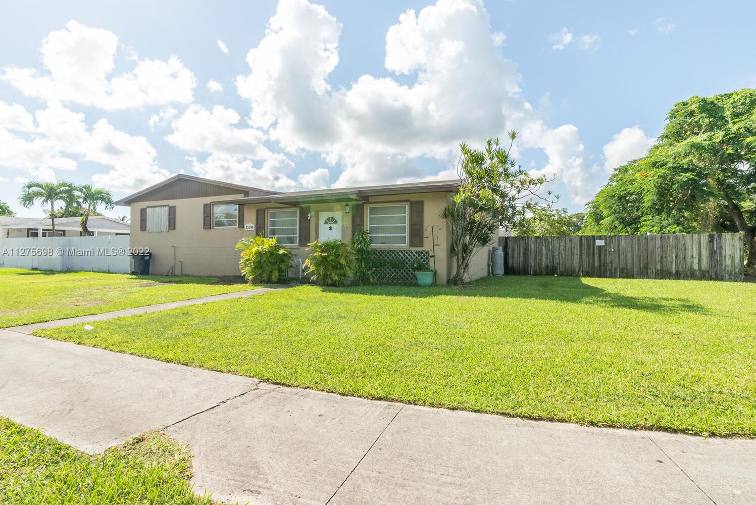 15140 Southwest 296th Street Homestead, FL 33033 - Photo 1 of 13 a front view of house with yard and green space