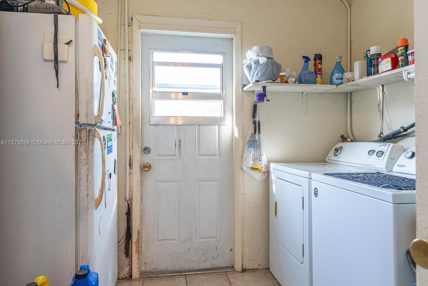 15140 Southwest 296th Street Homestead, FL 33033 - Photo 11 of 13 a utility room with cabinets washer and dryer