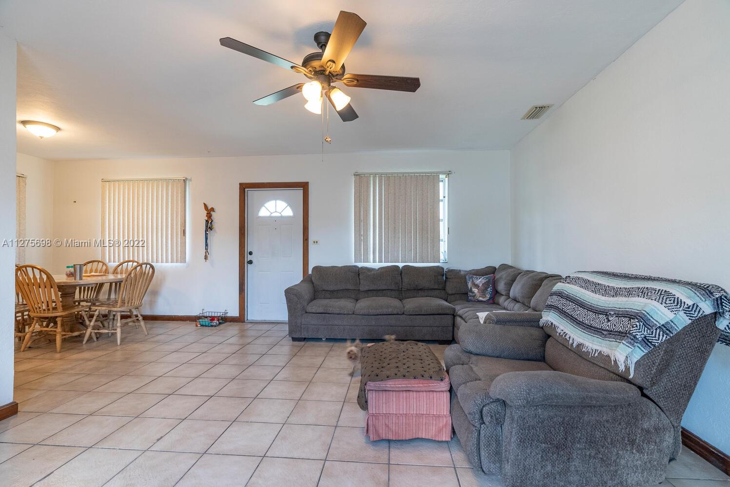 15140 Southwest 296th Street Homestead, FL 33033 - Photo 4 of 13 a living room with furniture and a dining table