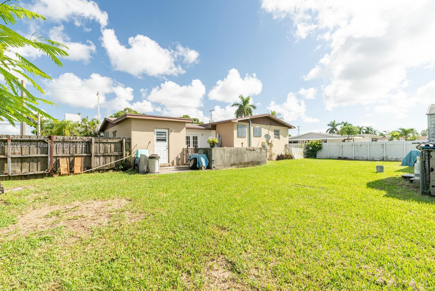 15140 Southwest 296th Street Homestead, FL 33033 - Photo 5 of 13 a front view of a house with yard and green space
