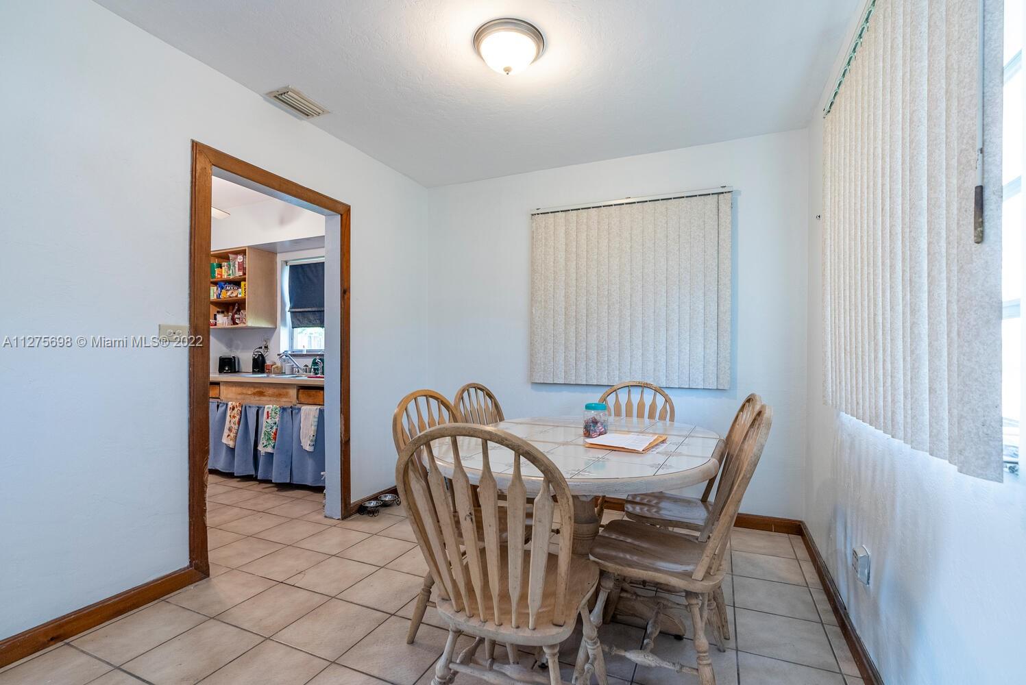 15140 Southwest 296th Street Homestead, FL 33033 - Photo 6 of 13 a dining room with furniture and window