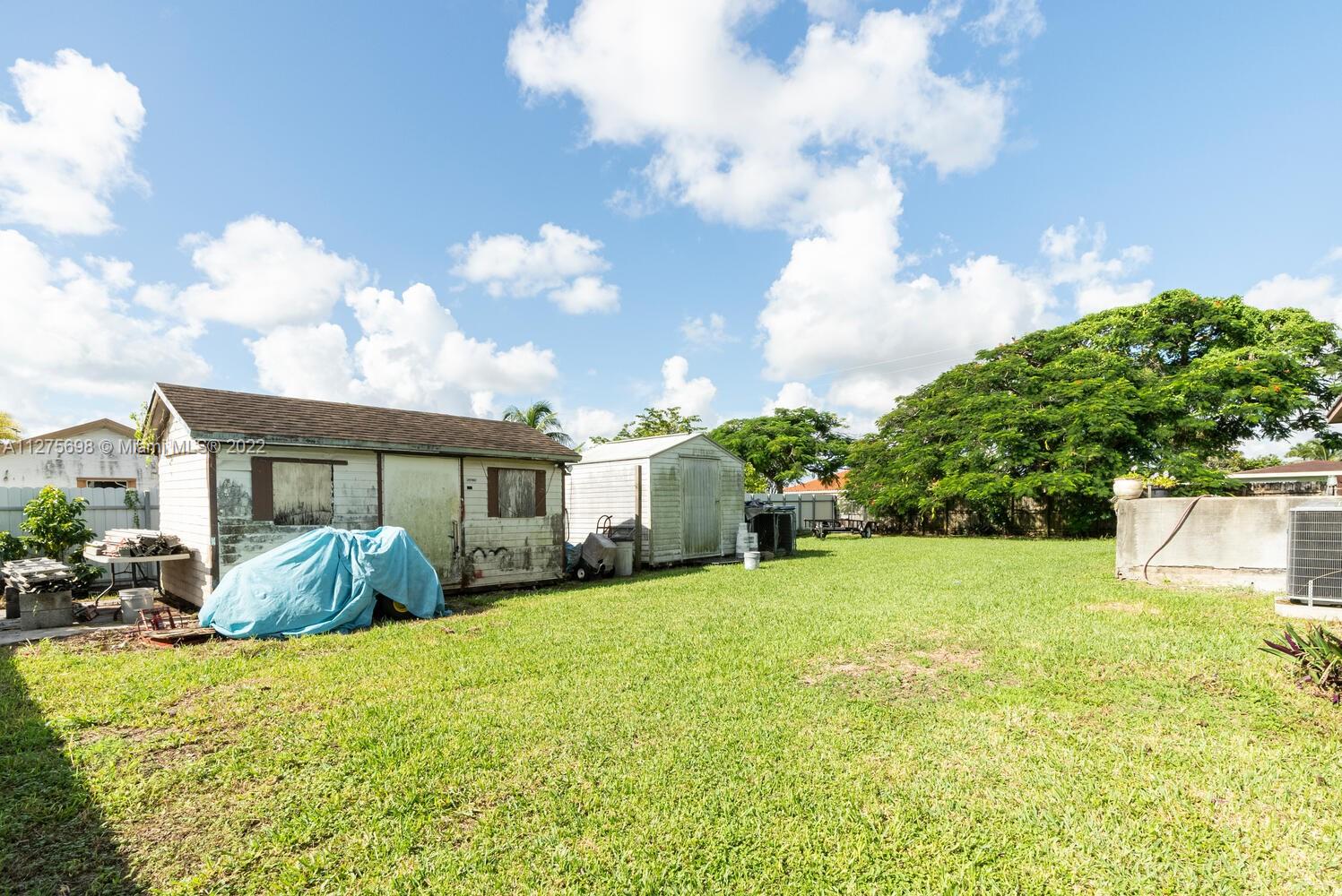 15140 Southwest 296th Street Homestead, FL 33033 - Photo 7 of 13 a front view of house with yard and trees