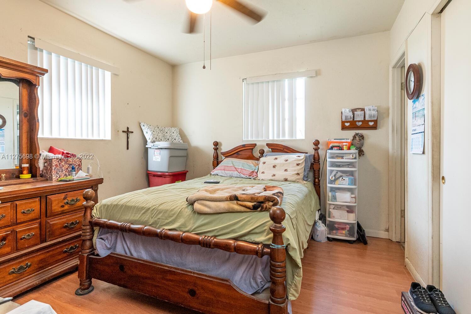15140 Southwest 296th Street Homestead, FL 33033 - Photo 10 of 13 a bedroom with a bed and a dresser in it