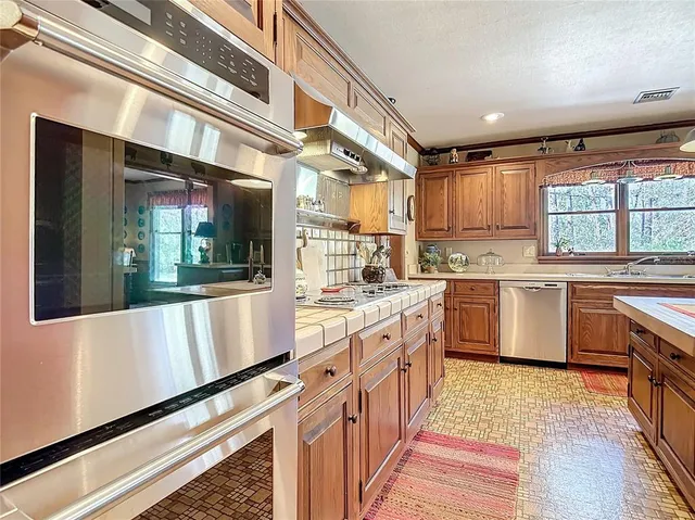 a living room with furniture large window and a fireplace